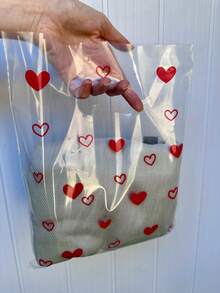 Sacola Plástica P Transparente Brilhoso Alça Vazada 25x30cm com Corações kit com 50 unidades - Visão 2