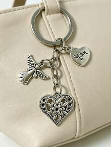 [1 pieza] Llavero vintage de plata con corazón de ángel para mamá, colgante de bolso con corazón de flor hueco, regalo del Día de la Madre para mujeres, colgante para mochila, dije de corazón de flor grabado para mamá, accesorio de bolso con tema familiar cálido, anillo de metal para llaves, soporte portátil anti-pérdida para llaves, decoración diaria para bolso, regalo conmovedor para mamá - Plateado - Ver 2