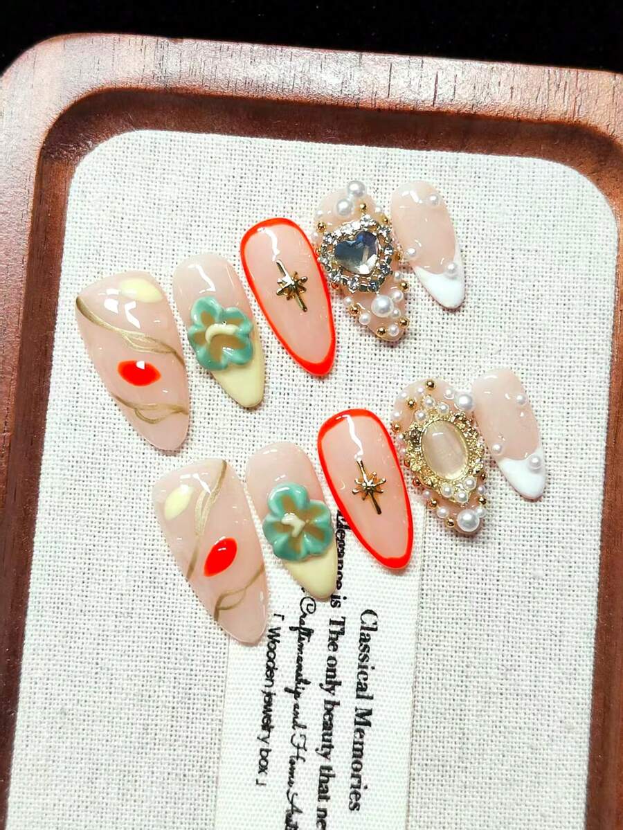 Press-On Fake Nails, Handmade Wearable Nails, Short Almond Shape, Nude With Yellow And White French Tips, Hand-Painted Gold Vine Lines, Orange-Red And Yellow Petals, Handmade 3D Embossed Green Flowers, Hand-Painted Orange-Red Outlines, Gold Starbursts, Oversized Iridescent Heart Rhinestones, Nude Oval Gemstones With Gold Trim, Gold And White Pearl Decorations, Vintage Luxury Style, Gentle And Sweet, Reusable
