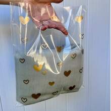 Sacola Plástica P Transparente Brilhoso Alça Vazada 25x30cm com Corações kit com 50 unidades - Visão 1