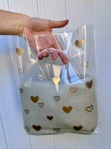 Sacola Plástica P Transparente Brilhoso Alça Vazada 25x30cm com Corações kit com 50 unidades - Visão 5