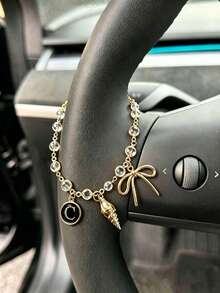 1 pieza Cadena de volante de coche con dije de letra inicial de concha y lazo de strass en tono dorado, estilo bohemio, cadena de metal para decoración interior de automóvil, accesorio ornamental personalizado para vehículo - A - Ver 11