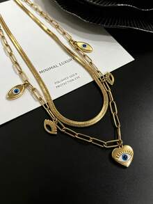Collar minimalista de dos capas chapado en oro, dije principal de corazón con ojo malvado y pequeños acentos de ojo, joyería hipoalergénica apilable para uso diario de damas - Collar de tres ojos de doble capa - Ver 1