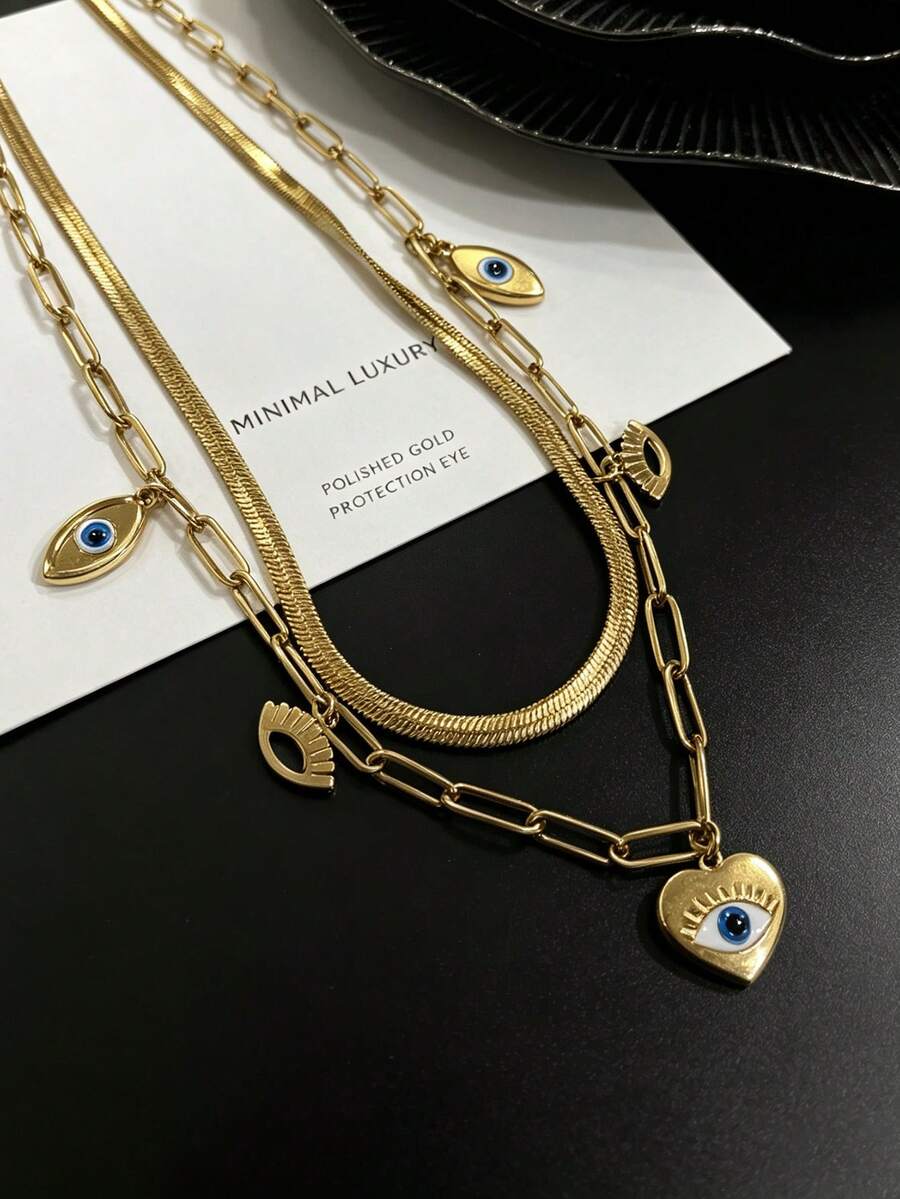 Collar minimalista de dos capas chapado en oro, dije principal de corazón con ojo malvado y pequeños acentos de ojo, joyería hipoalergénica apilable para uso diario de damas - Collar de tres ojos de doble capa - Ver 1