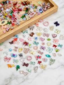 Aprox. 1100 piezas/100g de dijes mixtos para arte de uñas, estilo sexy con perlas, corazones, lazos y decoración de dibujos animados, accesorios de arte de uñas con flores, material de resina con forma de corazón de rosa, adecuado para joyería DIY, arte de uñas u otros accesorios decorativos, estilos aleatorios - aleatorio - Ver 4
