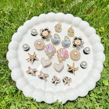 22 pezzi Ciondoli per scarpe serie oceano dorati, conchiglie, stelle marine, fiocchi, accessori fai-da-te, set di ciondoli per ciabatte forate - Dorato - Visualizzare 9