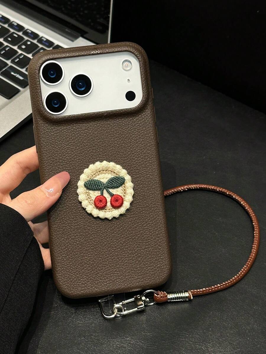Casing Ponsel Apple 17 Series, 14 Pro Max, dan Apple 11 Terlaris dengan Bordir Cherry Cokelat Tua dan Tali Kulit. - Coklat - View 1