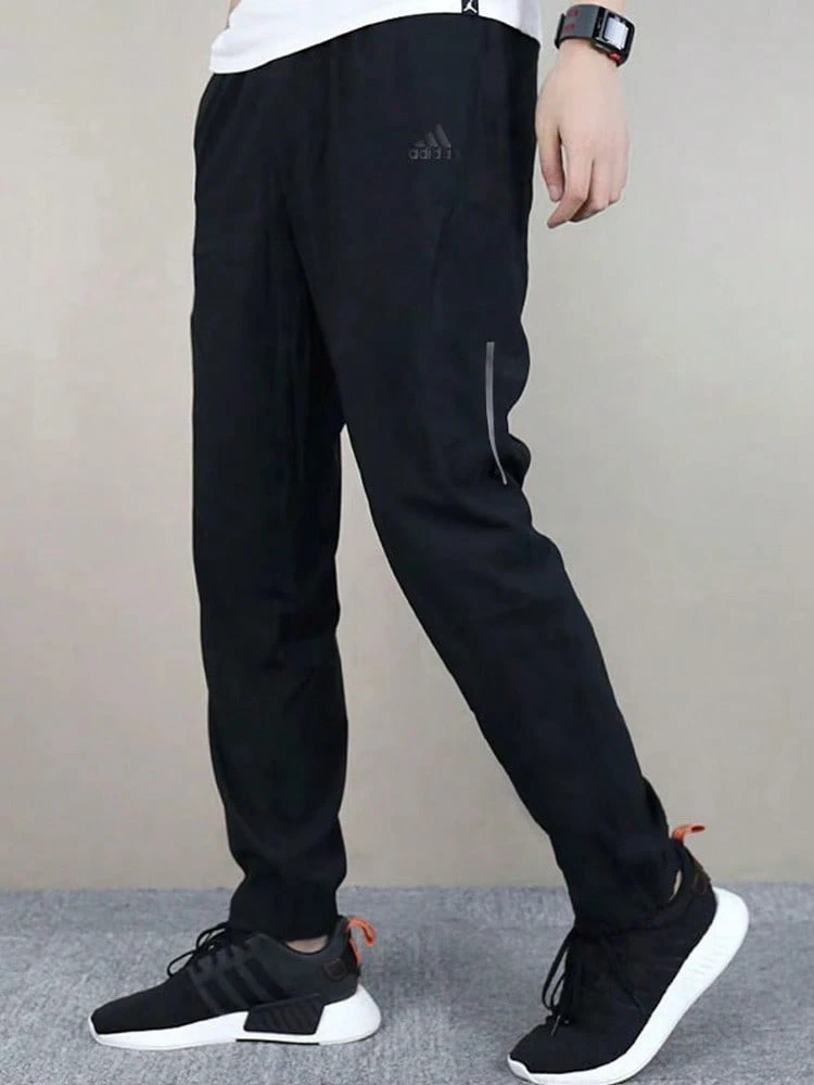 Celana Sweatpants Kasual Rajut dengan Resleting adidas Supernova untuk Pria - Hitam - View 1