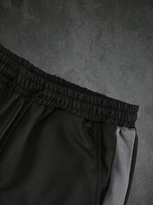 طقم رجالي من قطعتين، بلوزة رياضية بياقة دائرية مضلعة بتصميم ألوان متداخلة ورقعات وخطوط داخلية، سترة رياضية علوية عصرية مع حبل شد وجيوب مائلة، بنطال رياضي طويل ضيق، خريف/شتاء - الأسود - مشاهدة 9