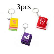 Lindo juguete de estrés en forma de libro miniatura para presionar con el dedo - Juguete antiestrés con páginas 3D que se pueden pasar, decoración colgante para mochila, juguete sensorial para aliviar la ansiedad - Multicolor - Ver 10