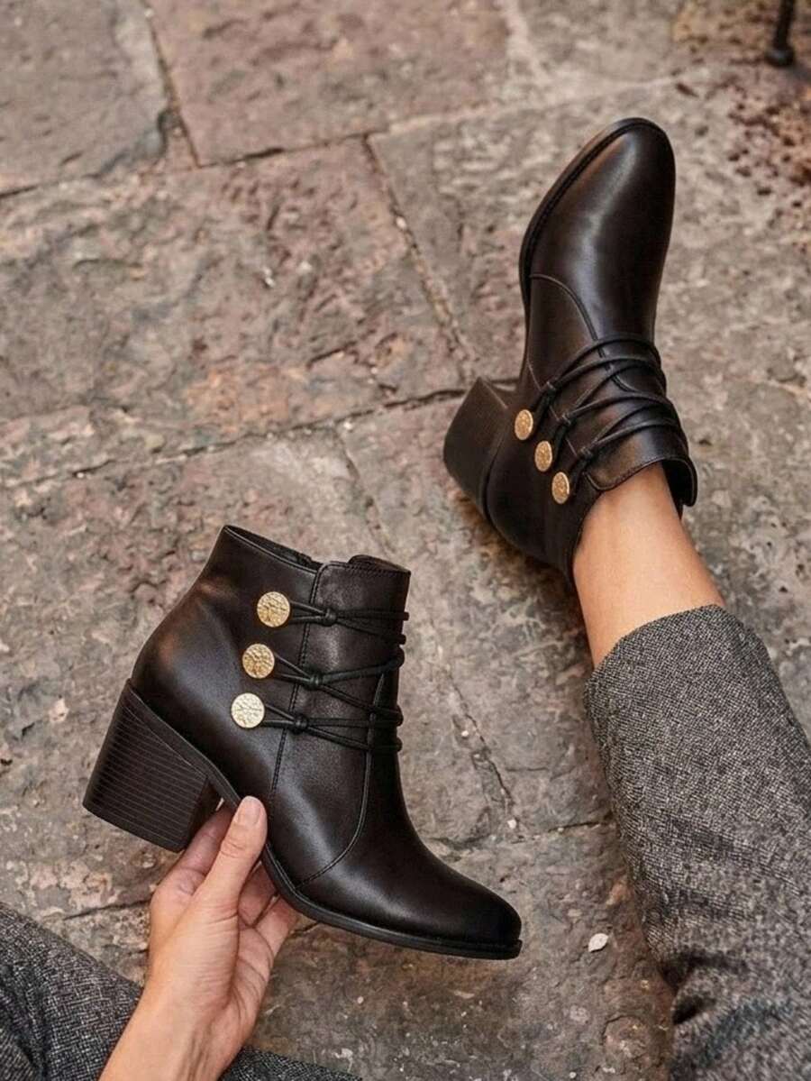 Botín elegante de mujer, piel genuina, con tacón medio, detalle de botones metálicos y ajuste tipo agujeta. Disponible en colores negro y café. Ideal para looks casuales o formales - Negro - Ver 1