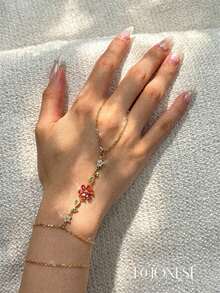 EchoNest 1pc Golden Stainless Steel Red Flower Linked Finger Bracelet With Zirconia, Vacation Party Finger Chain Decorative Accessory - Yellow Gold - View 1