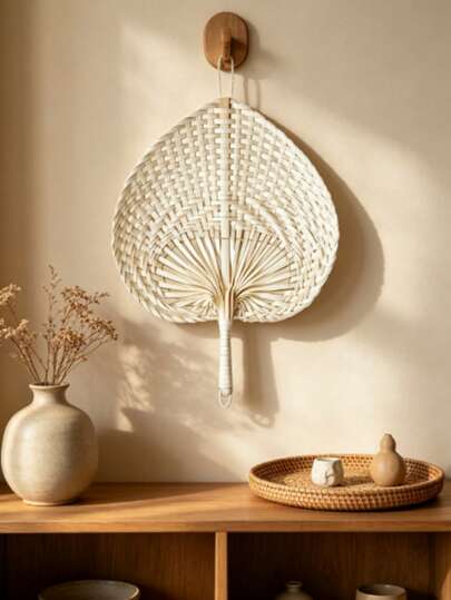 A 15cm Wide Hand-Woven Heart-Shaped Fan With A Unique Peach-Shaped Decorative Accent. Ultra-Thin And Lightweight, Suitable For Both Indoor And Outdoor Use As A Handheld Fan For Cooling Off.
