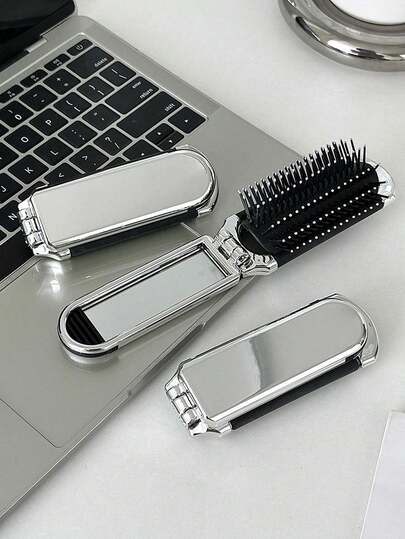 A Glossy Electroplated Silver Comb With A Foldable Design And A Small Mirror, Compact And Portable