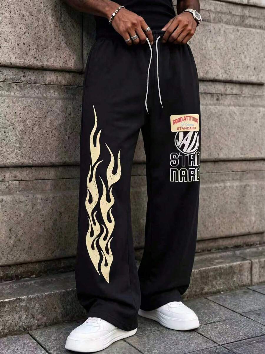 MAISONFOX Men's Black Loose Sweatpants, Vintage Cream Flame Pattern & Patchwork Text, Drawstring Wide Leg Joggers, Retro Skateboard Streetwear Long Pants - Black - View 1