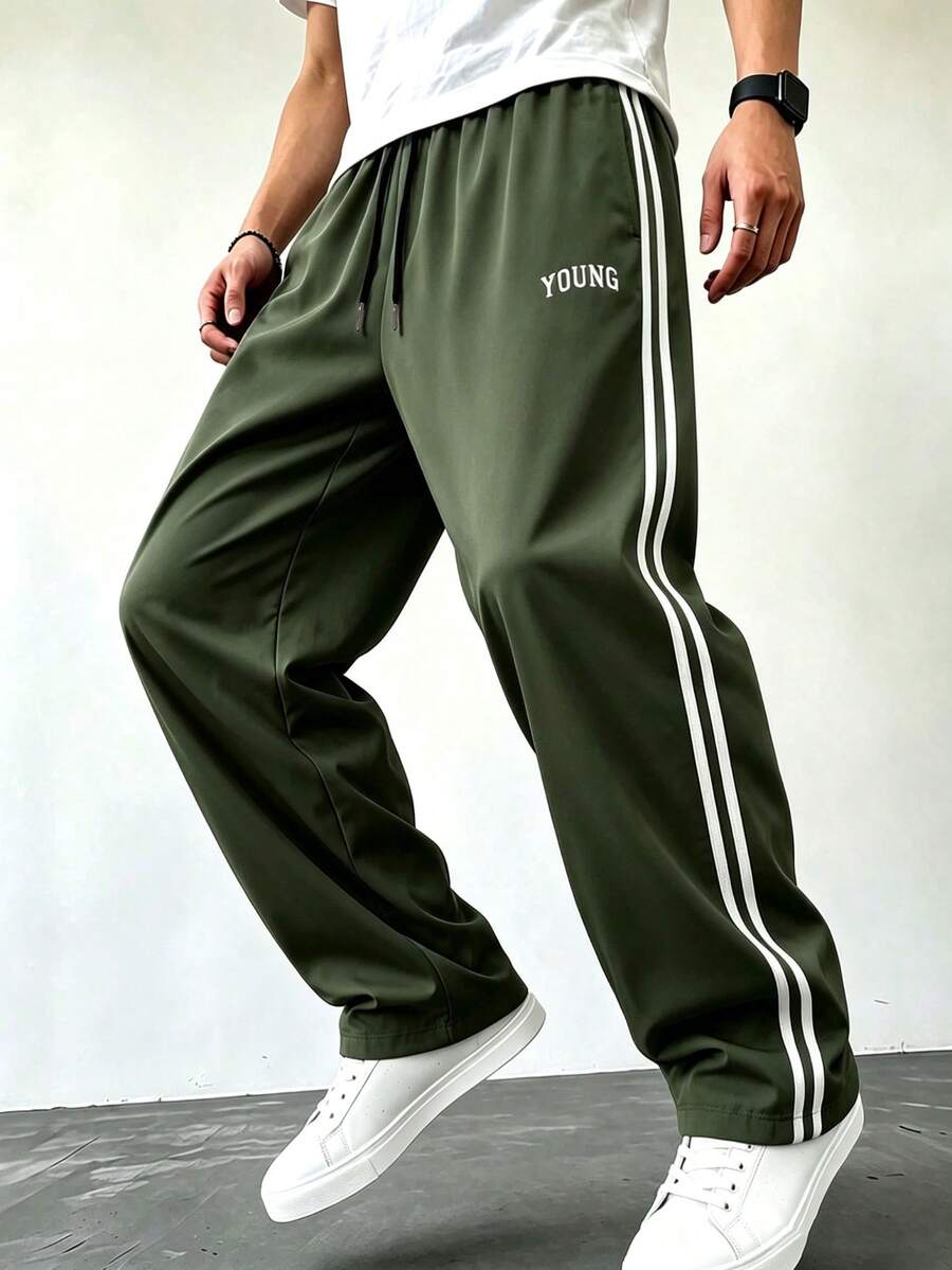 男士軍綠色運動長褲,寬鬆版型,健身運動褲,條紋側邊,字母圖案,抽繩腰頭,開口褲腳 - 軍綠色 - 查看 1