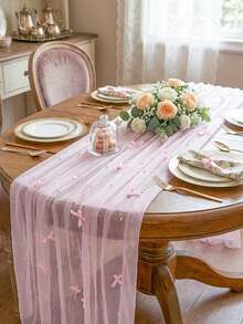 Laço rosa com pérolas