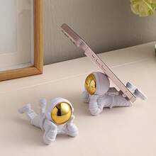 1pc Prone Astronaut Resin Sculpture, Hand-Polished Astronaut Figurine, Multi-Functional Phone Holder Desktop Ornament, Home Office Decor - Multiple Styles - View 1