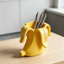 1pc Creative Banana Shaped Pen Holder, Minimalist INS Style Desktop Storage Decor. Realistic 3D Banana Design, Unique And Creative. Can Store Various Stationery, Makeup Brushes And Small Accessories, Smooth Craftsmanship For Hands. Desk, Office Desktop, Dual Use For Storage And Decoration, Niche And Stylish, Full Of Healing Vibes. - View 1
