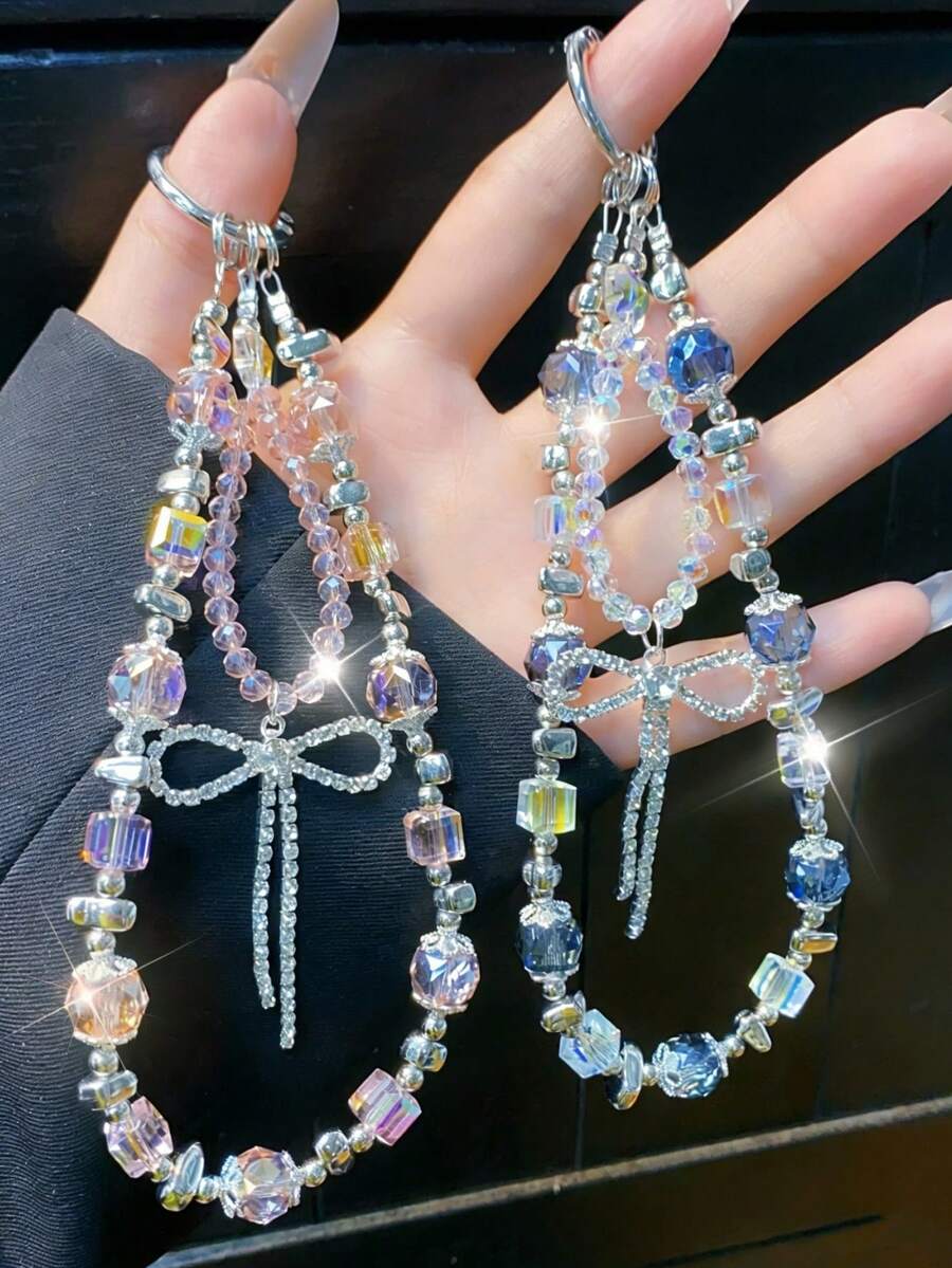 1件裝美學雙色手機掛繩，附蝴蝶結、水晶流蘇與扣環，獨特百搭裝飾掛帶，適合女性通勤使用