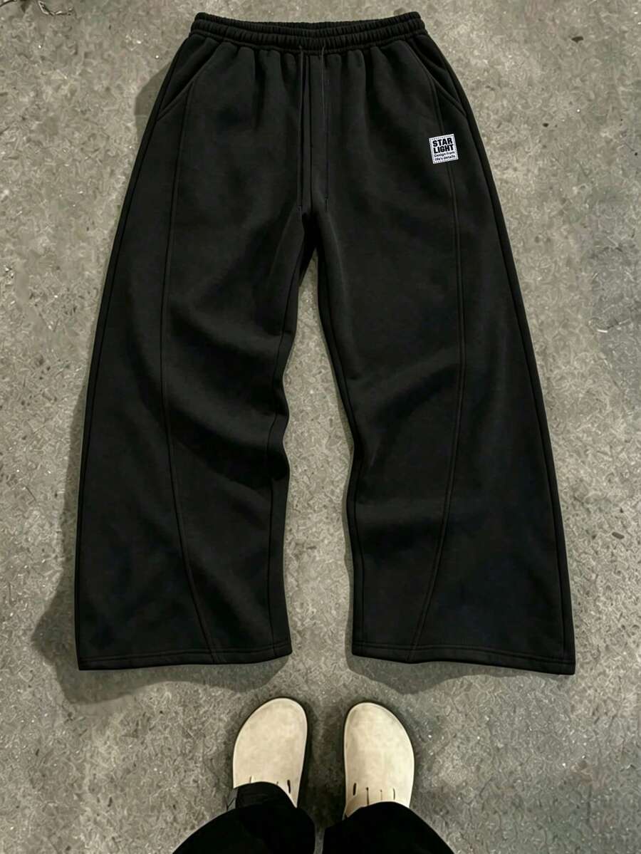 Unisex Split Seam Wide Leg Sweatpants, Comfortable Knit Sports Fabric, White Contrast Drawstring, Small STAR LIGHT Letter Patch On Waist Side, 3D Cut Loose Wide Leg Casual Long Pants, Available In Multiple Colors - Black - View 1