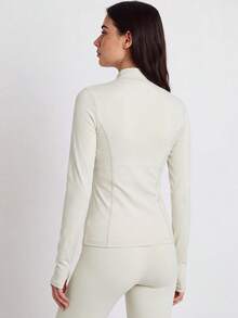 VUTRU Women's Slim Fit Dual Pocket Sports Jacket With Zipper, Thumb Holes And Small Stand Collar For Running And Fitness - Creamy White - View 2