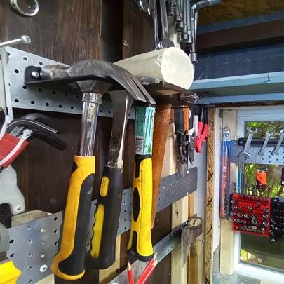 A Sturdy Black Metal Tool Storage Rack, Versatile In Its Functions, Meets The Storage Needs Of Various Workshops, And Ensures A Neat And Organized Home Space Through High-Quality Products.