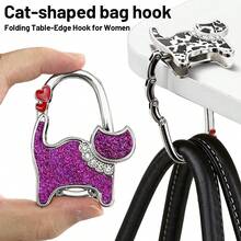 Cute Cat-Shaped Foldable Table Edge Hook, Compact And Portable, Can Be Carried In Bag. Simply Clip To Table Edge To Hang Bags And Handbags, Freeing Up Your Hands. Simple And Adorable Design, Both A Practical Storage Item And A Creative Gift For Women. - View 1