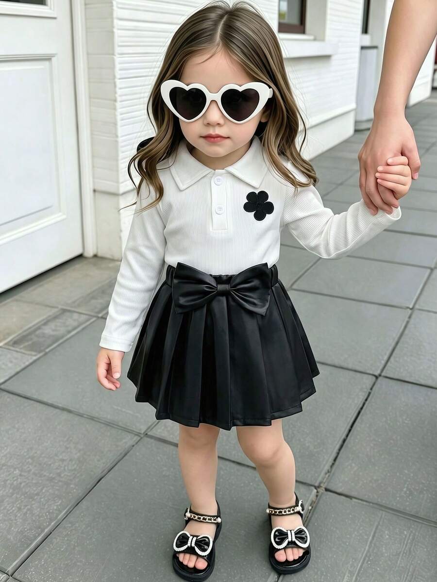2pcs Baby Girl Sweet Elegant Outfit: White Ribbed Polo Neck Floral Sweatshirt Top + 3D Bow Pleated Faux Leather Mini Skirt Set - White - View 1