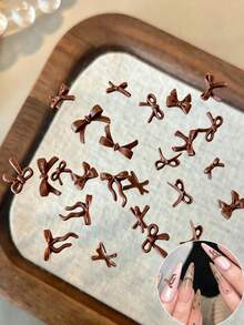 100pcs Solid Matte Brown 3D Ribbon Nail Art Decorations, Mixed Resin Bows In Various Shapes, Autumn/Winter Mini Ribbon Nail Accessories, DIY Nail Design, Nail Supplies - Brown - View 1