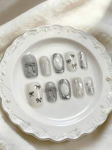 10pcs Medium Gray Silver Bow Nail Stickers, Minimalist Elegant Style, Featuring Bow And Line Patterns, Using Nude Tie Dye And 3D Decorative Techniques, Suitable For Young And Mature Women, Applicable For Workplace, Formal Dates, And Refined Parties, Comes With Jelly Gel And Nail File - Silver - View 1