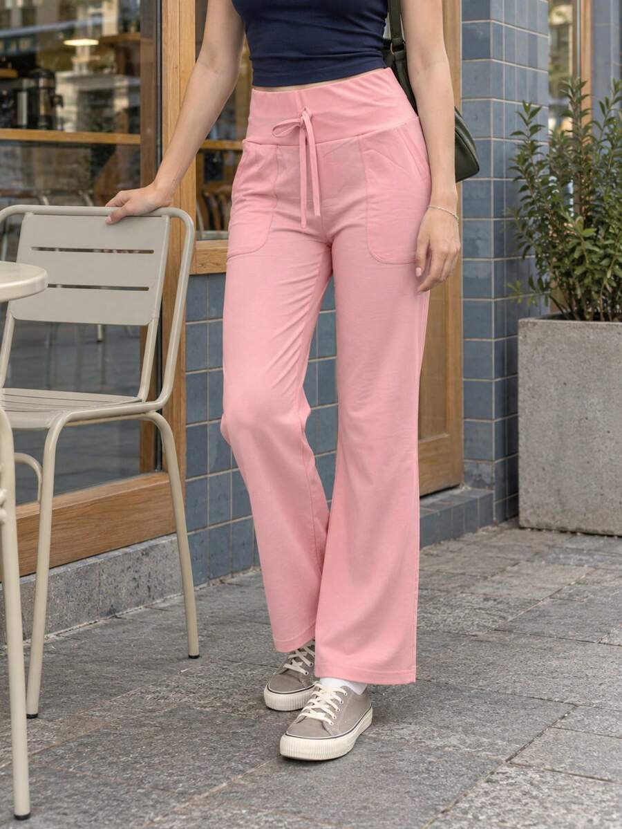 Pantalón acampanado para mujer, deportivo y casual. Ajuste de cintura alto, cordón decorativo no ajustable. Bolsillos funcionales. Interior fresco y cómodo. Colores lisos sin estampado. - Rosa Pálido - Ver 1
