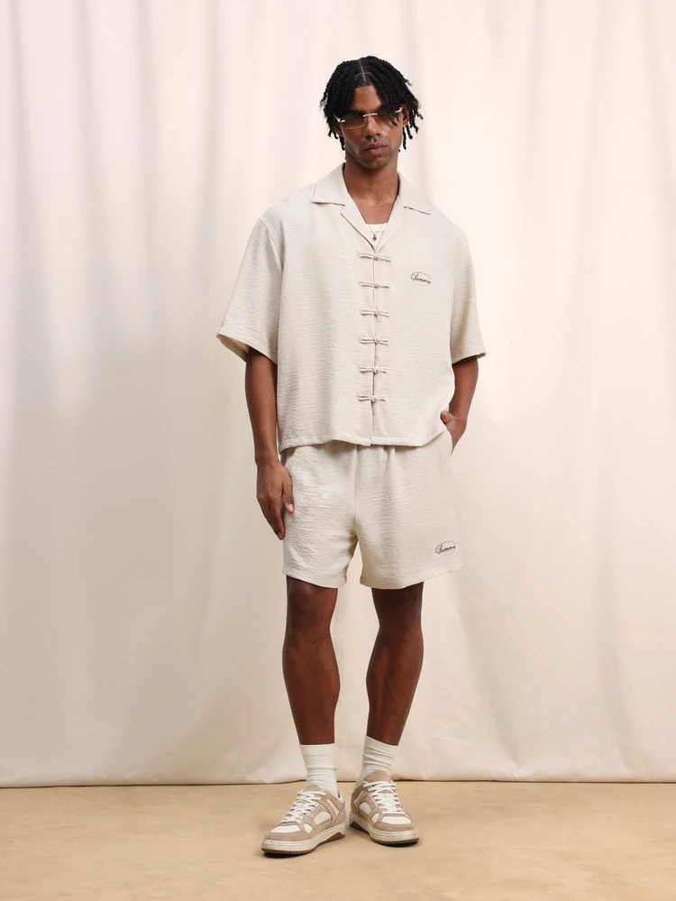 Beige Relaxed Fit Short Sleeve Shirt And Matching Shorts Co-Ord Set With Button Front Closure And Elastic Waist Summer Casual Two Piece Outfit