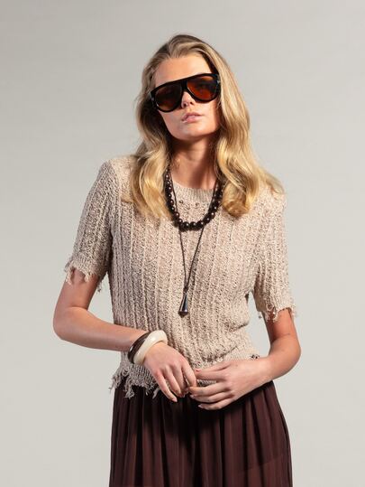 Rouah Luxury Boho Premium Summer Textured Knit Top In Beige. This Artistic Short-Sleeve Sweater Features A Sophisticated Crew Neckline And Unique Distressed Frayed Edging For A High-End Artisan Feel. Crafted From A Premium Ribbed Open-Knit Fabric, This Breathable Top Is Perfect For Luxury Coastal Vacations, Boho-Chic Summer Parties, Or Elevated Daytime Events. The Relaxed Yet Tailored Fit Pairs Effortlessly With Flowy Maxi Skirts Or Linen Pants, Offering A Textural And Sophisticated Staple For Summer