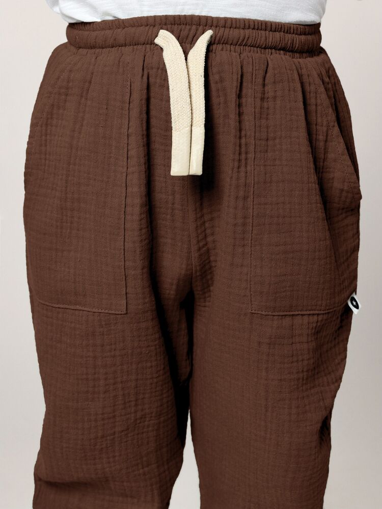 Pantalones cargo de algodón muselina de ajuste relajado con bolsillos traseros y puños ajustables para uso casual diario