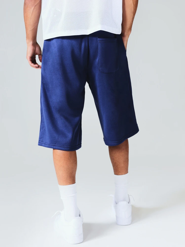 Short en velours avec passepoil, jambes larges, cordon de serrage avec bordure contrastée et détail de logo