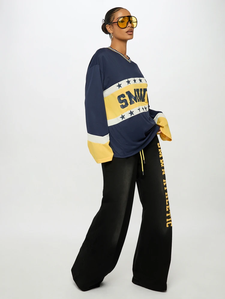 Oversized Weite Bein Jogginghose mit Vintage-Waschung, vertikalem Logo-Seitendruck und gelbem Kordelzug