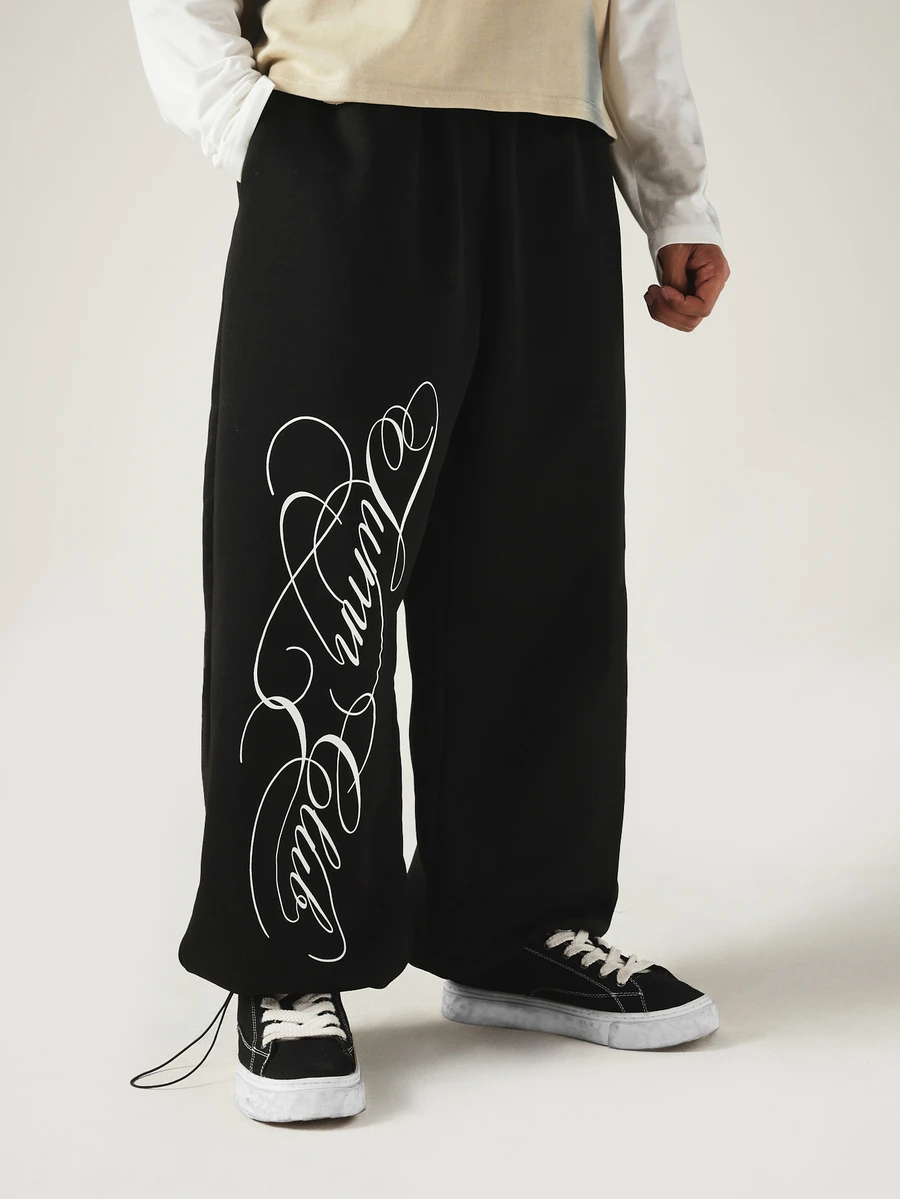 SUMWON Wide Leg Black Sweatpants With Oversized Cursive Script Leg Print Drawstring Hem Streetwear Style - Black - View 1