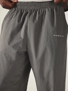 SUMWON Pantalones de chándal de pierna ancha con bajo de abertura lateral, cintura elástica y bolsillos laterales, detalle reflectante, pantalones de tejido color carbón - Gris - Ver 5