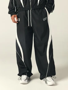 SUMWON Wide Leg Track Pants With White Contrast Panels Piping Elastic Waist Drawstring Ankle Hem Logo Embroidery Number Patch Fall Winter - Black and White - View 1