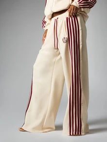 BABYPHAT Wide Leg Track Pants With Burgundy Side Stripe Panel Snap Button Detail Drawstring Waist And Embroidered Sheild Logo - Apricot - View 1