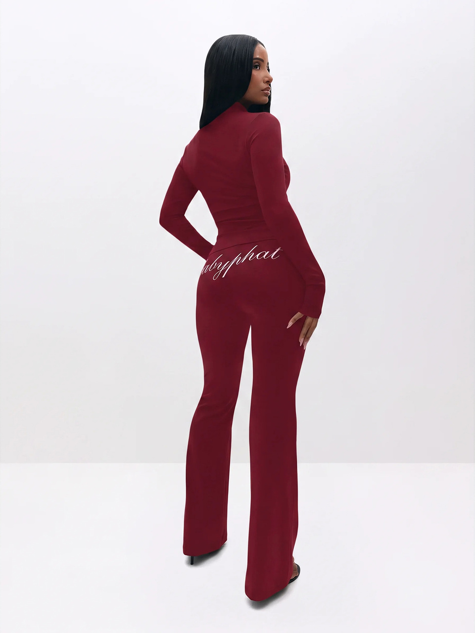 BABYPHAT Logo Zip-Front Mock Neck Long Sleeve Flare Leg Jumpsuit With Script Back Print And Cat Emblem Detail