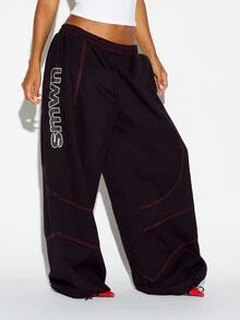 SUMWON WOMEN Oversized Baggy Casual Pants With Red Contrast Stitching Vertical Logo Leg Print And Elastic Ankle Drawstring Detail - Black - View 4