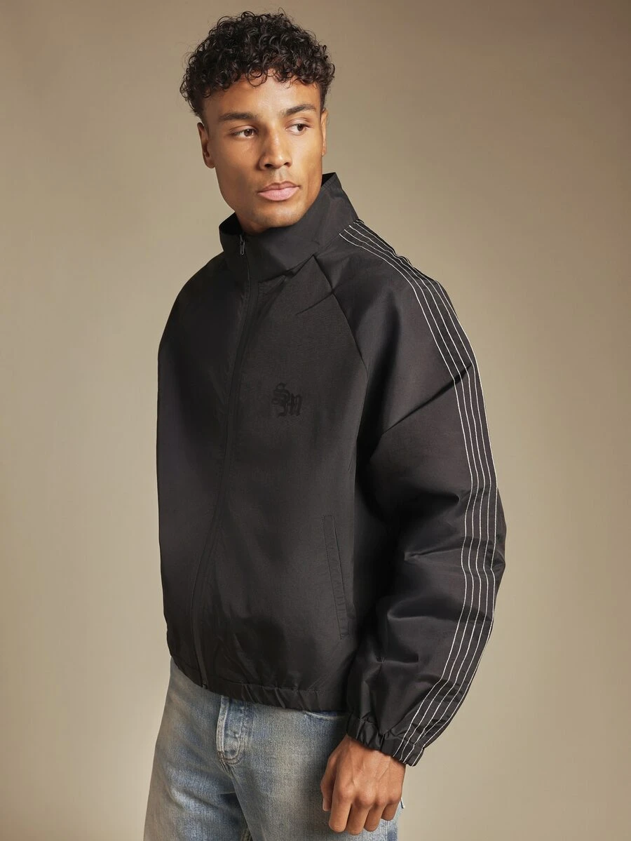 SUMWON Oversized Windbreaker Jacket With Zip Closure Mandarin Collar And Contrast Stripe Sleeve Detail With Embroidered Logo - Black - View 1