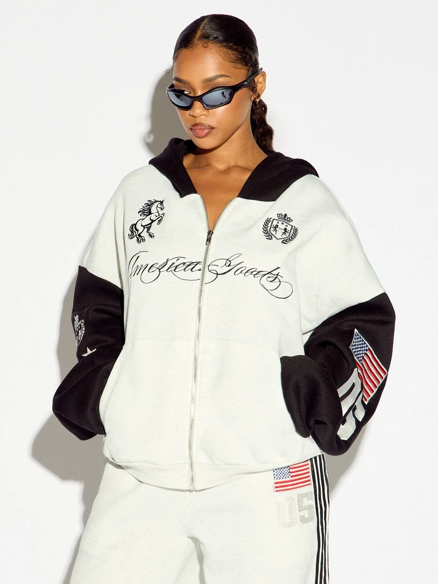 SUMWON WOMEN Boxy Fit America Goods Full-Zip Oversized Sweatshirt With Embroidered Unicorn Sheild Graphic And American Flag Patch Sleeve Detail - Black and White - View 1