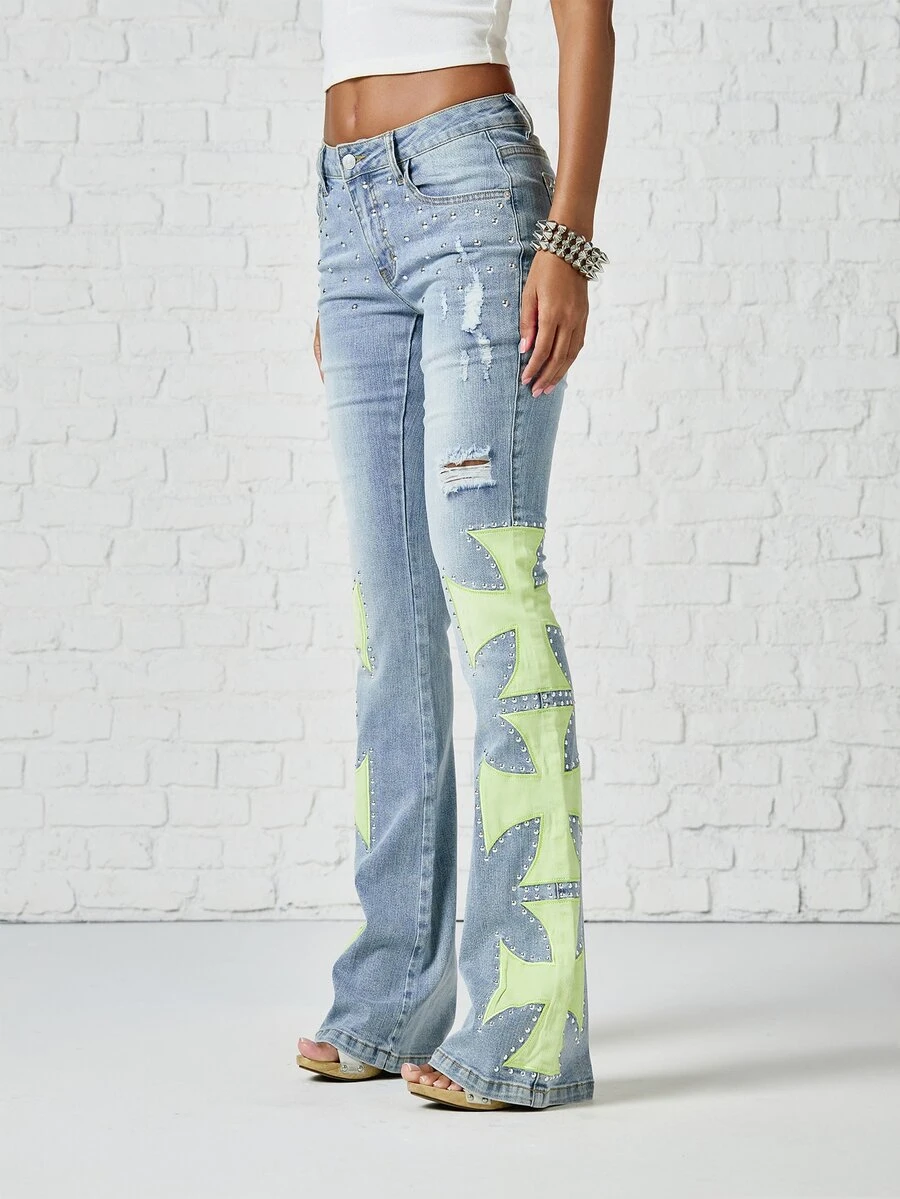 SUMWON WOMEN Low Rise Flared Jeans With Neon Green Cross Applique Panels Studded Rhinestone Embellishments And Distressed Ripped Details Festival Season - Light Wash - View 1