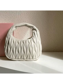 A small sheepskin dumpling bag under the armpit, a one-shoulder crossbody crescent-shaped women's bag, and a mini cloud bag