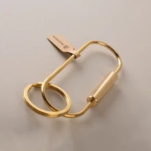 BLKSMTH BLKSMTH BRASS PENDANT IN THE SHAPE OF A PAPER CLIP