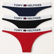 Set de 3 tangas de algodón TOMY HELFIGER para mujer, ropa interior cómoda y ligera con elástico suave en la cintura que no marca la piel, ideal para uso diario y moda íntima juvenil y casual. Diseño clásico tipo tanga con costuras delicadas y ajuste perfecto en cadera y cintura, confeccionadas en algodón transpirable que ofrece frescura durante todo el día. Colores surtidos rojo, negro y azul marino fáciles de combinar con brasieres y tops, prendas de lencería versátiles para ocasiones casuales o especiales. Tanga de mujer con estilo moderno, sexy y discreto debajo de cualquier prenda de vestir. Pack de 3 piezas de ropa interior femenina de calidad premium, pensadas para brindar comodidad, durabilidad y estilo en el día a día. - Multicolor - Ver 3