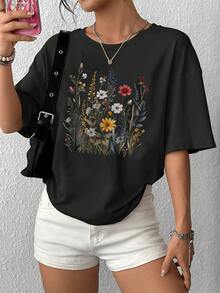 Elegante camiseta de mujer con estampado floral vibrante, camiseta informal de manga corta con cuello redondo, elegante diseño gráfico para uso diario, cómoda y de moda. - Negro - Ver 1